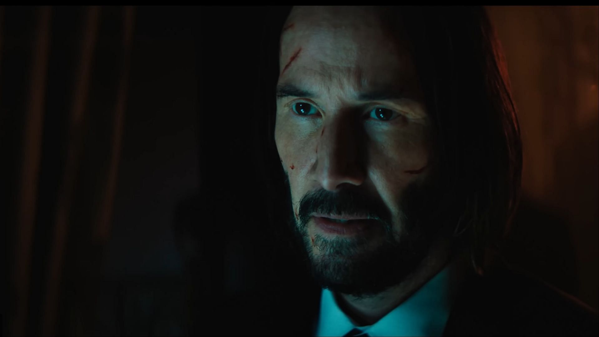 John Wick watches silently, calculating whether Eve is a threat or a kindred spirit. (Image via Lionsgate Movies)